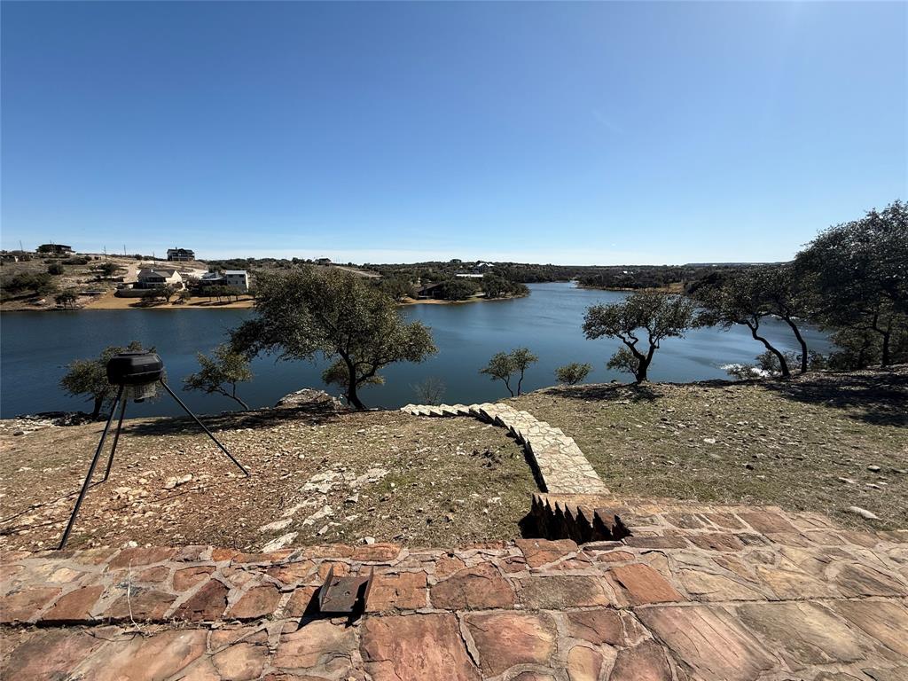 7037 Hells Gate Loop Strawn, TX 76475 - Photo 3 of 10 a view of a lake with a mountain