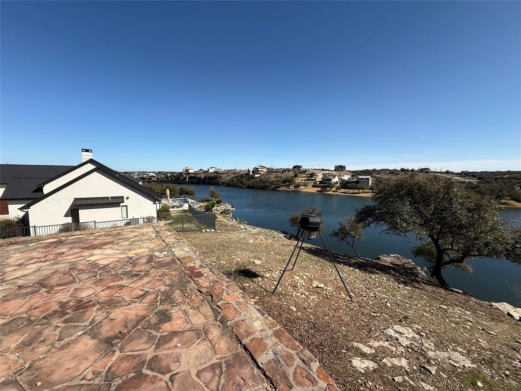 7037 Hells Gate Loop Strawn, TX 76475 - Photo 4 of 10 a view of a lake with a house