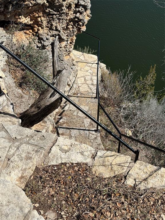 7037 Hells Gate Loop Strawn, TX 76475 - Photo 8 of 10 a view of a yard covered with snow in the background