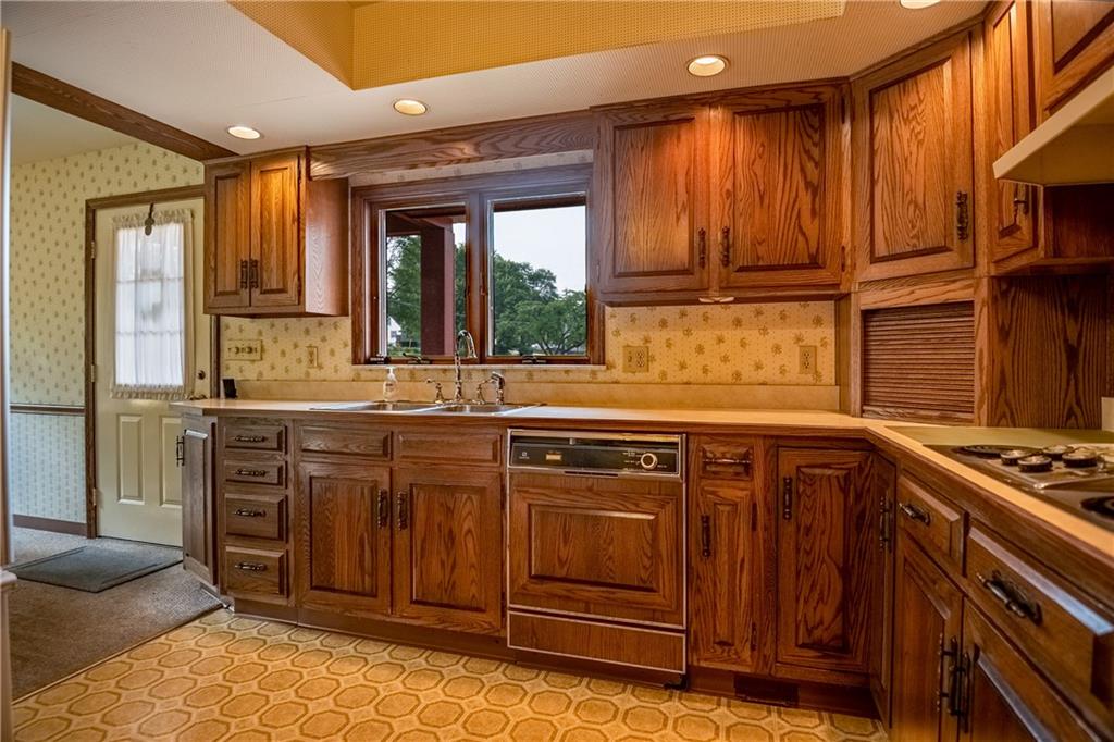 856 Sugar Hollow Road Hermitage, PA 16148 - Photo 11 of 18 a kitchen with stainless steel appliances granite countertop wooden cabinets and a stove top oven