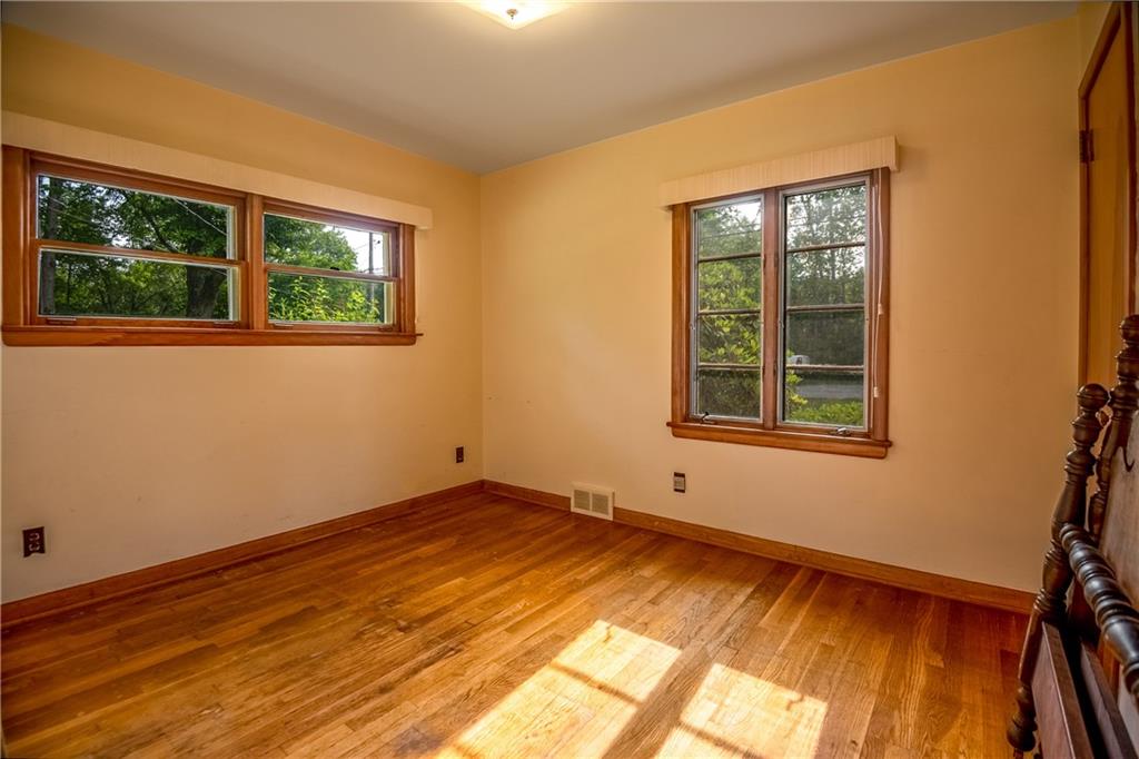 856 Sugar Hollow Road Hermitage, PA 16148 - Photo 16 of 18 a view of an empty room with a window and wooden floor