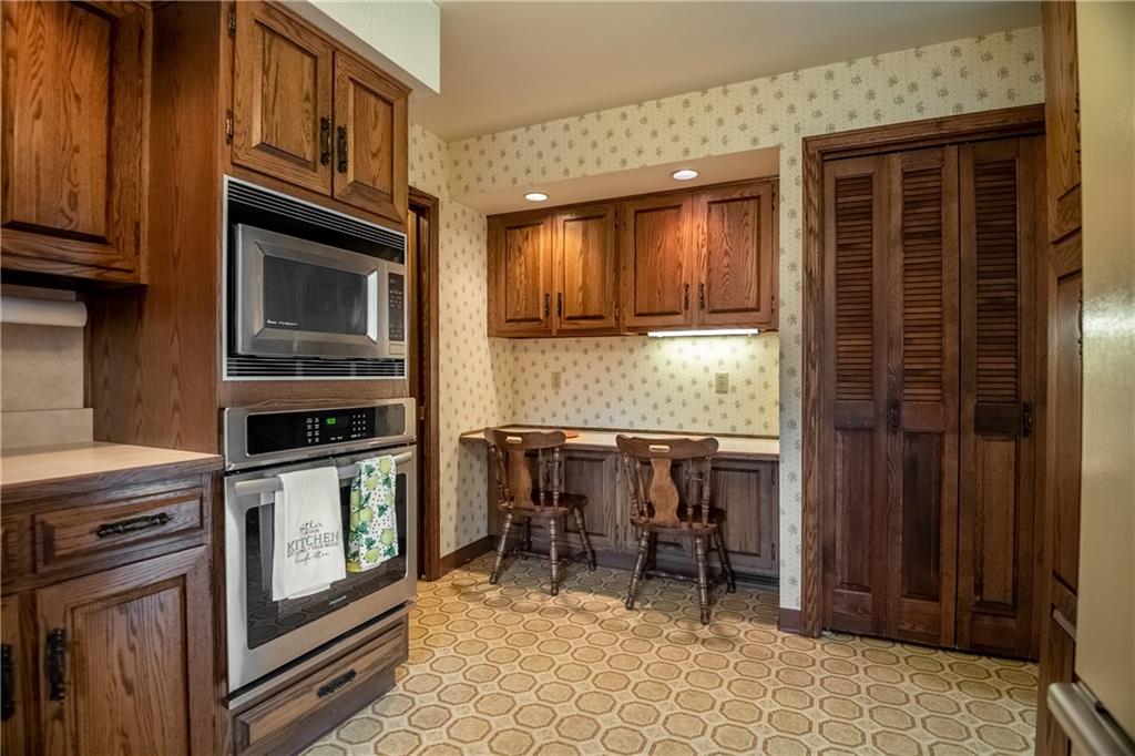 856 Sugar Hollow Road Hermitage, PA 16148 - Photo 10 of 18 a kitchen with granite countertop a stove top oven cabinets dining table and a sink