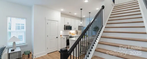 a view of entryway with wooden floor and stairs