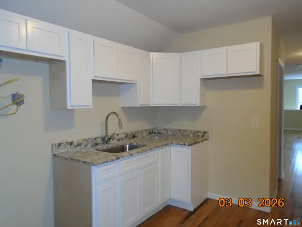 a kitchen with stainless steel appliances granite countertop a sink and a granite counter tops