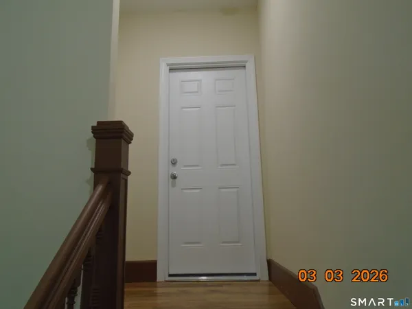 a view of hallway with wooden floor