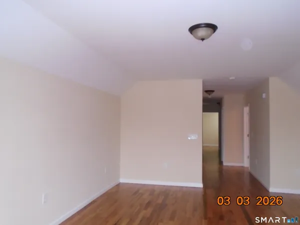 a view of a room with wooden floor