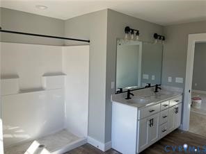 15335 Lebanon Road Spring Grove, VA 23881 - Photo 22 of 28 a bathroom with a granite countertop sink and a mirror