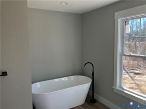 15335 Lebanon Road Spring Grove, VA 23881 - Photo 24 of 28 a white bath tub sitting next to a window