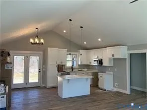 a large kitchen with cabinets and wooden floor
