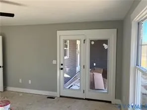 a bathroom with a glass door and a shower