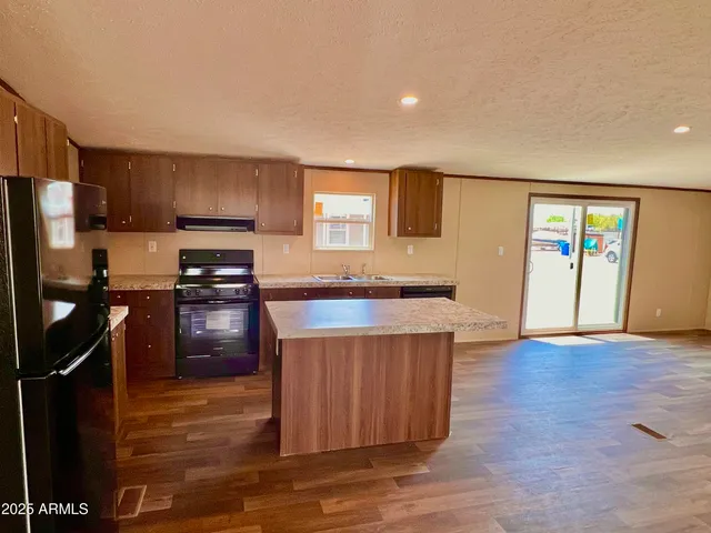 a kitchen with a sink a stove and refrigerator