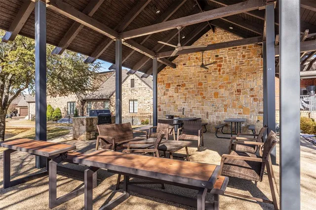 an aerial view of a house with swimming pool and large trees