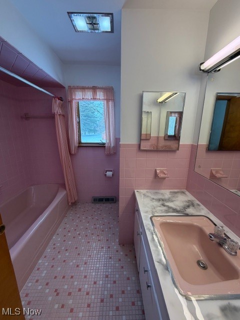 1933 Arndale Road Stow, OH 44224 - Photo 9 of 21 Bathroom featuring vanity, shower / bath combination with curtain, tile walls, a wainscoted wall, and tile patterned flooring