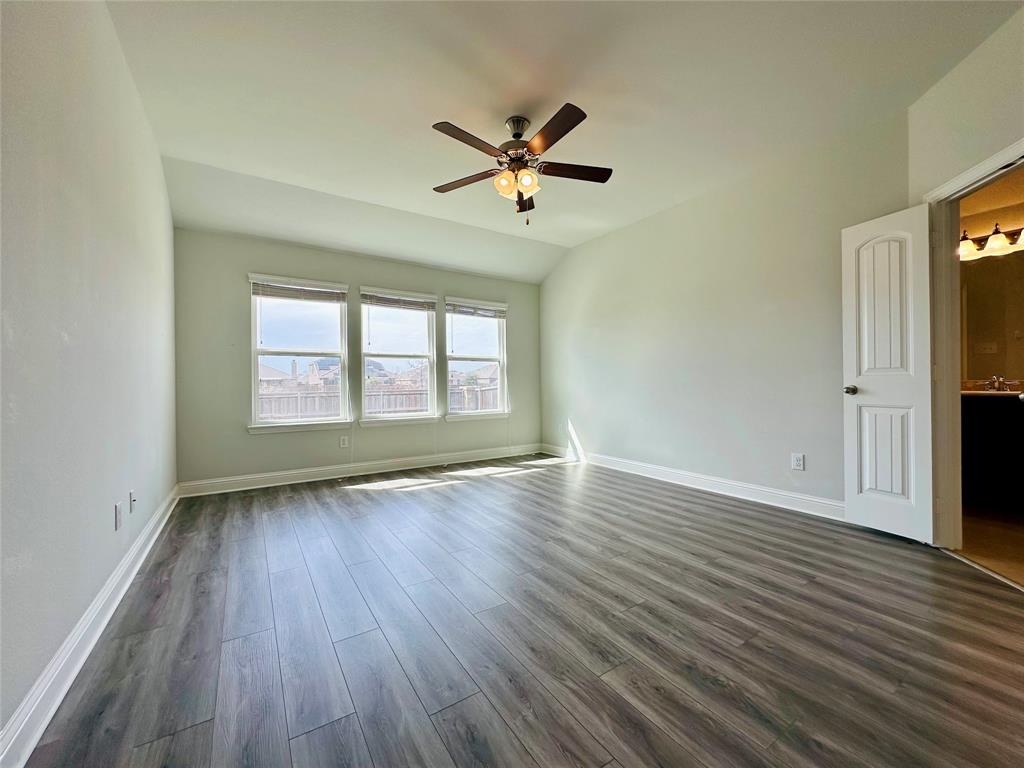 1223 Mount Olive Lane Forney, TX 75126 - Photo 21 of 28 Spare room featuring a ceiling fan, dark wood-style flooring, and vaulted ceiling