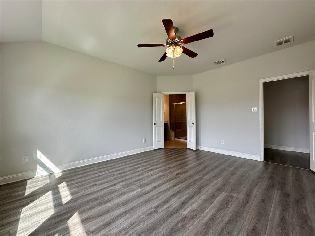 1223 Mount Olive Lane Forney, TX 75126 - Photo 22 of 28 Unfurnished bedroom featuring dark wood-style floors and a ceiling fan