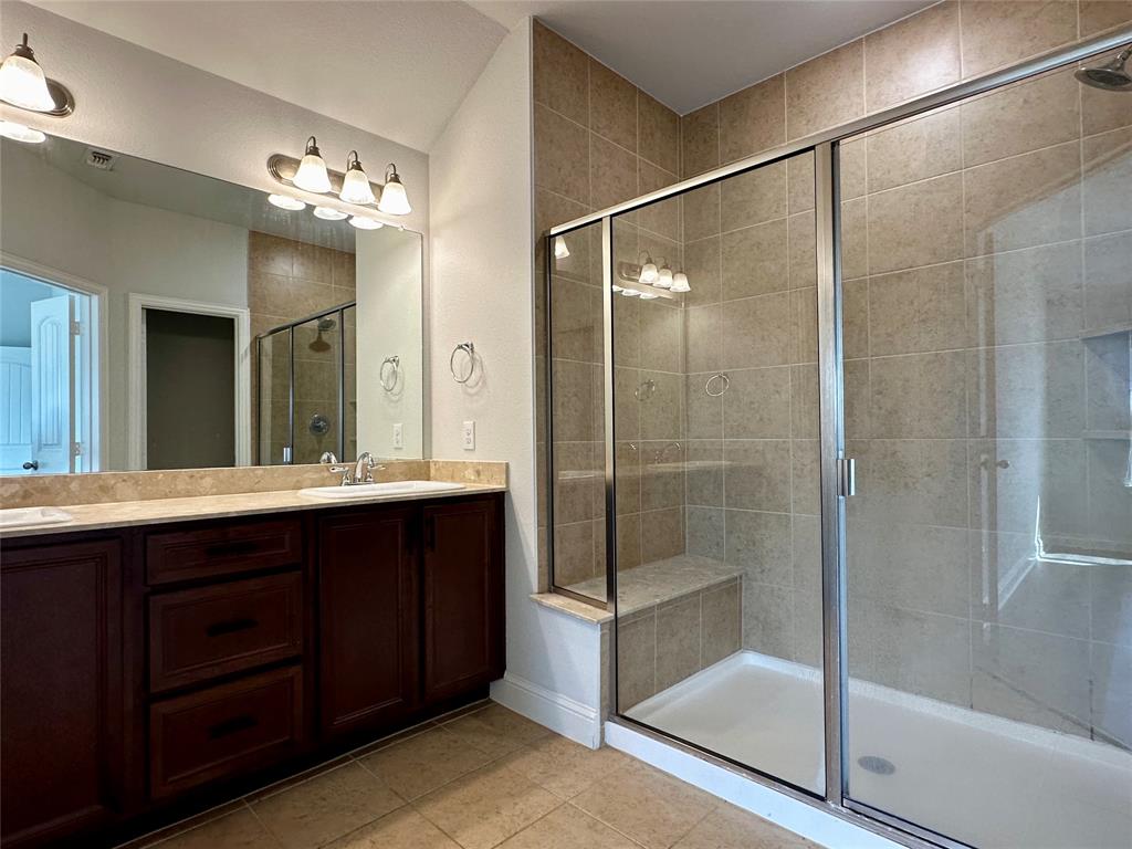 1223 Mount Olive Lane Forney, TX 75126 - Photo 23 of 28 Bathroom with a shower stall, double vanity, and light tile patterned floors