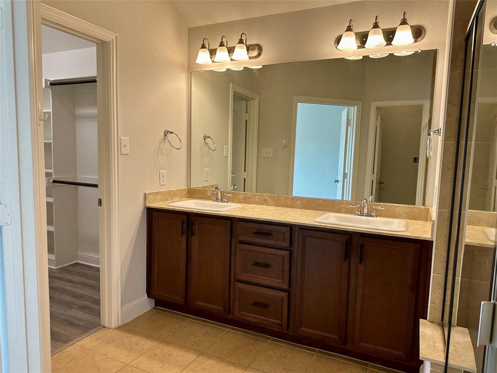 1223 Mount Olive Lane Forney, TX 75126 - Photo 24 of 28 Full bath with double vanity, a stall shower, a walk in closet, and light tile patterned floors