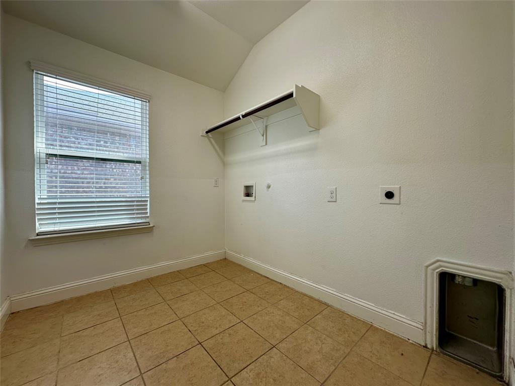 1223 Mount Olive Lane Forney, TX 75126 - Photo 26 of 28 Laundry room with hookup for a gas dryer, electric dryer hookup, washer hookup, vaulted ceiling, and light tile patterned flooring