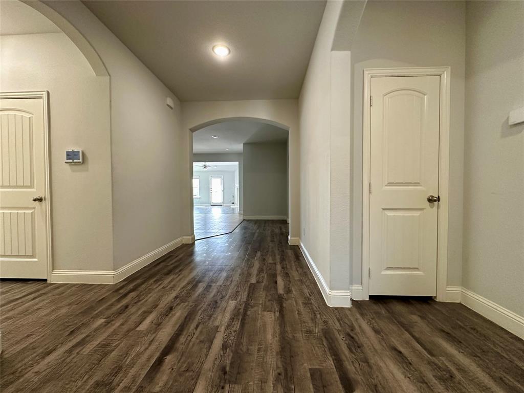 1223 Mount Olive Lane Forney, TX 75126 - Photo 3 of 28 Hall featuring arched walkways and dark wood finished floors