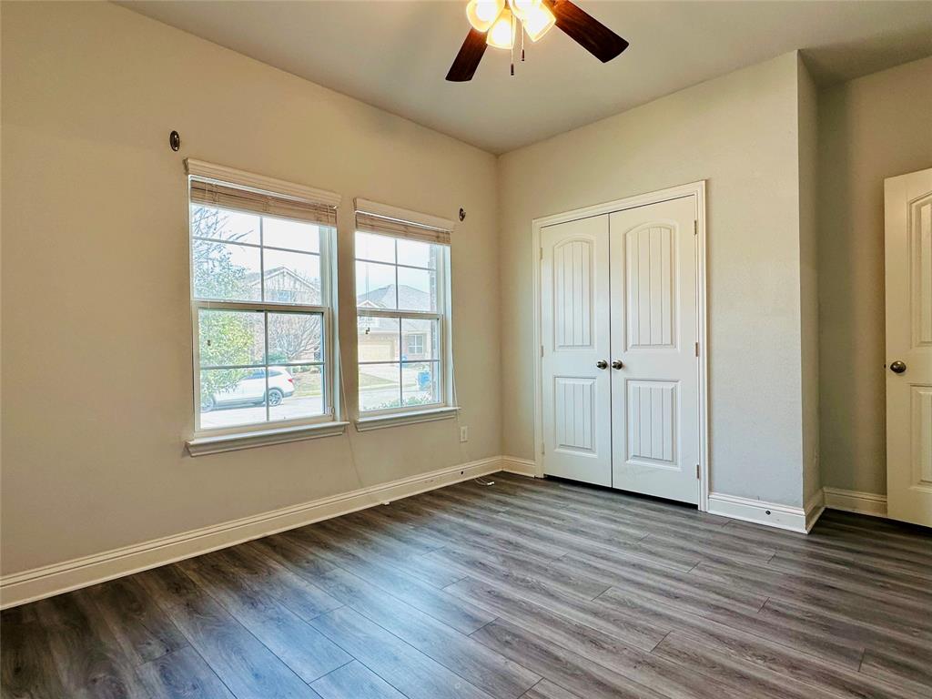 1223 Mount Olive Lane Forney, TX 75126 - Photo 9 of 28 Unfurnished bedroom featuring dark wood-style floors, a closet, and ceiling fan