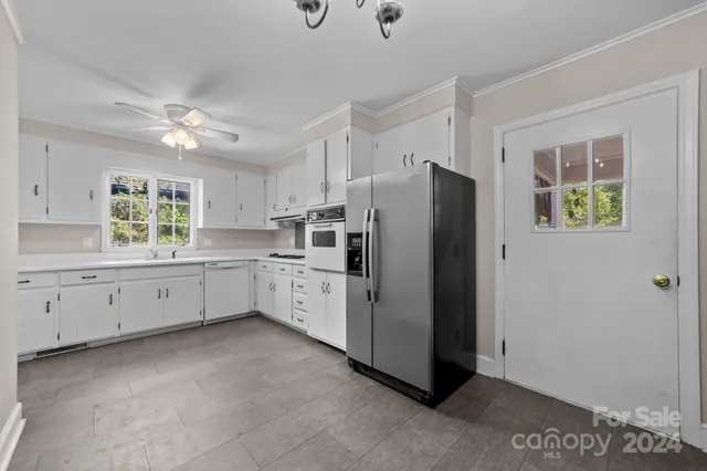a kitchen with refrigerator and window
