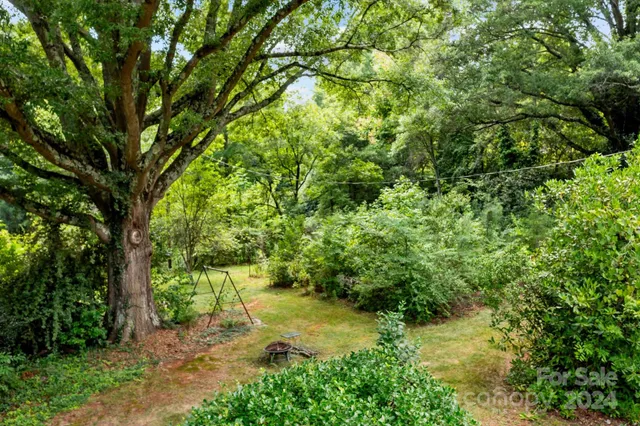 a backyard of a house with a yard and outdoor seating