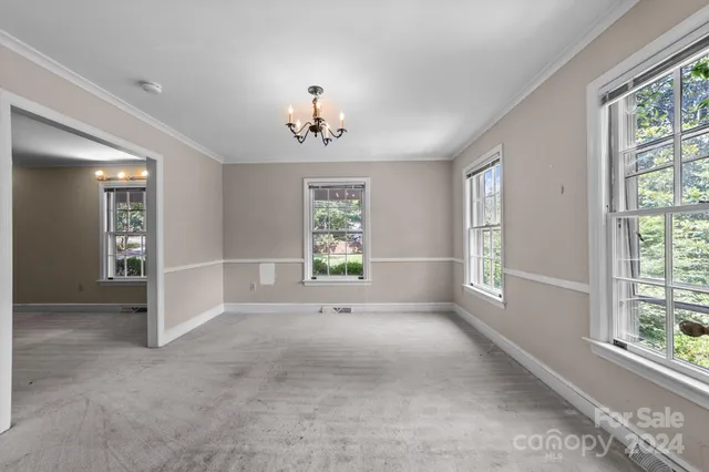 an empty room with windows and entrance