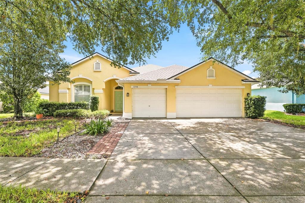 16748 Midsummer Lane Spring Hill, FL 34610 - Photo 4 of 52 a front view of a house with garden