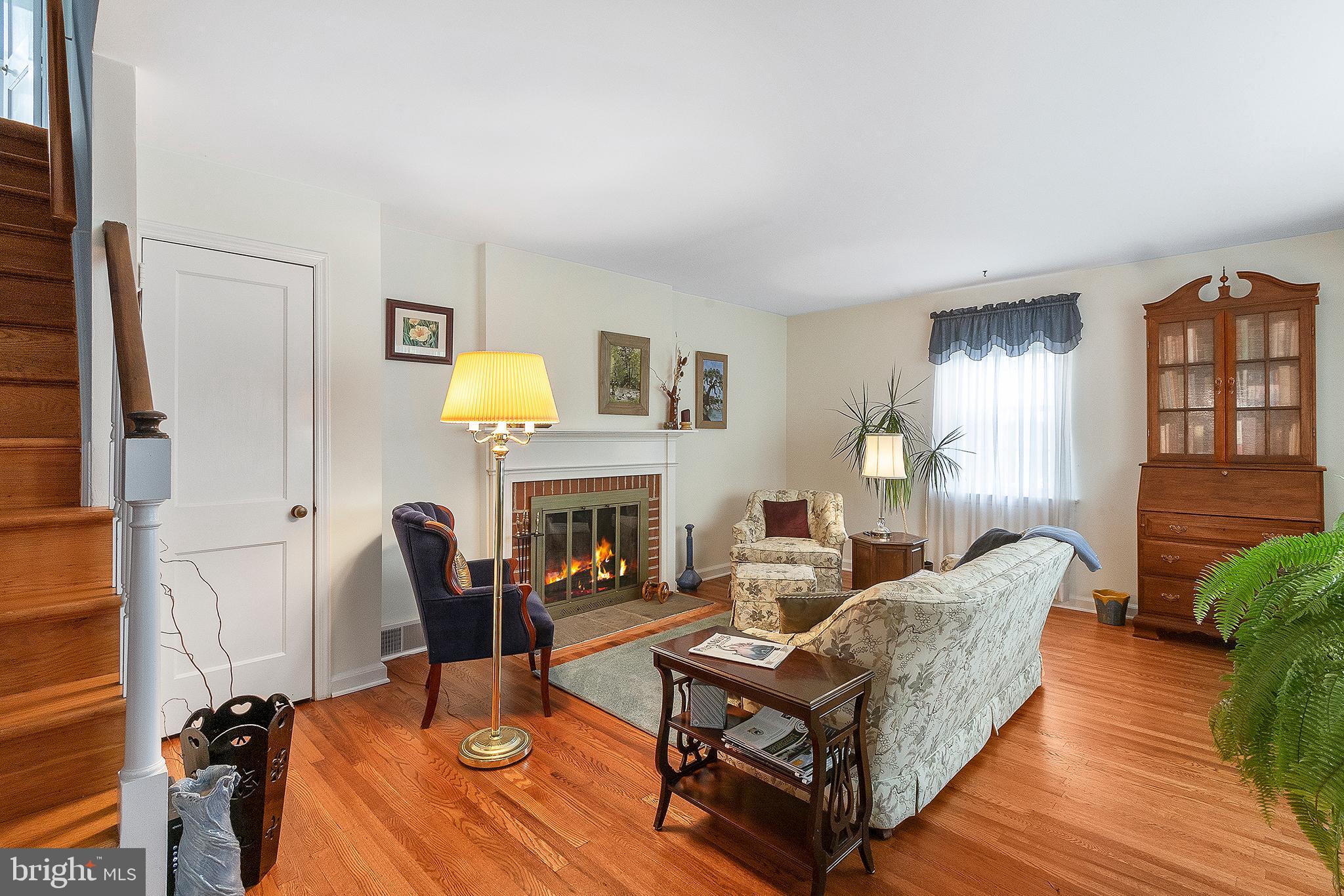 608 East Valley Green Road Flourtown, PA 19031 - Photo 3 of 26 a living room with furniture a fireplace and a potted plant