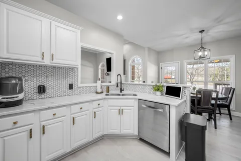 a spacious bedroom with a bed couch and a large window