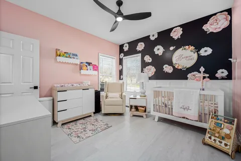 a view of a house with a big yard and large trees