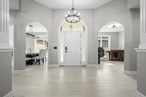 a living room with furniture and a chandelier