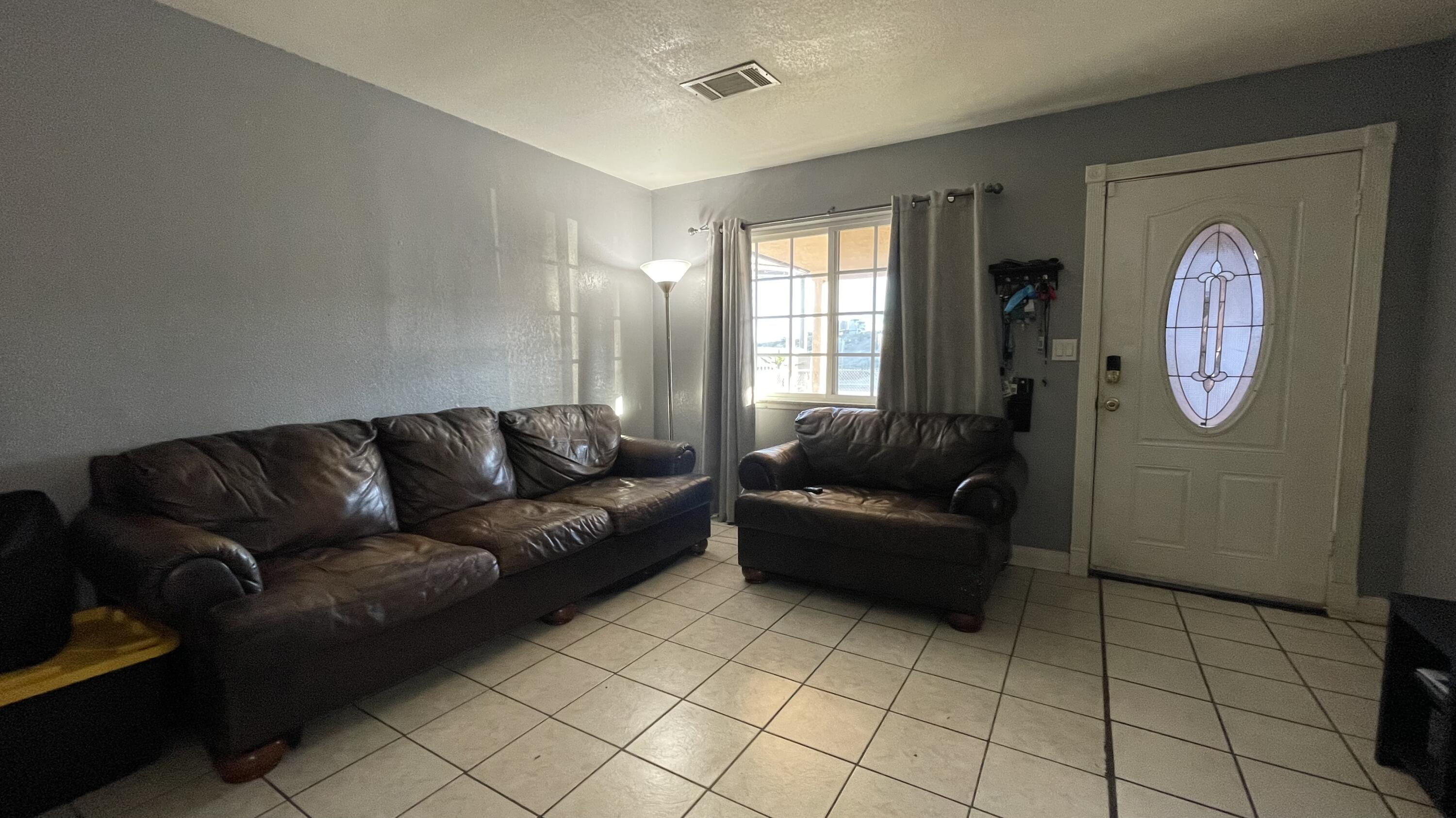 83644 Ave 44 Indio, CA 92203 - Photo 11 of 24 a living room with furniture and a window