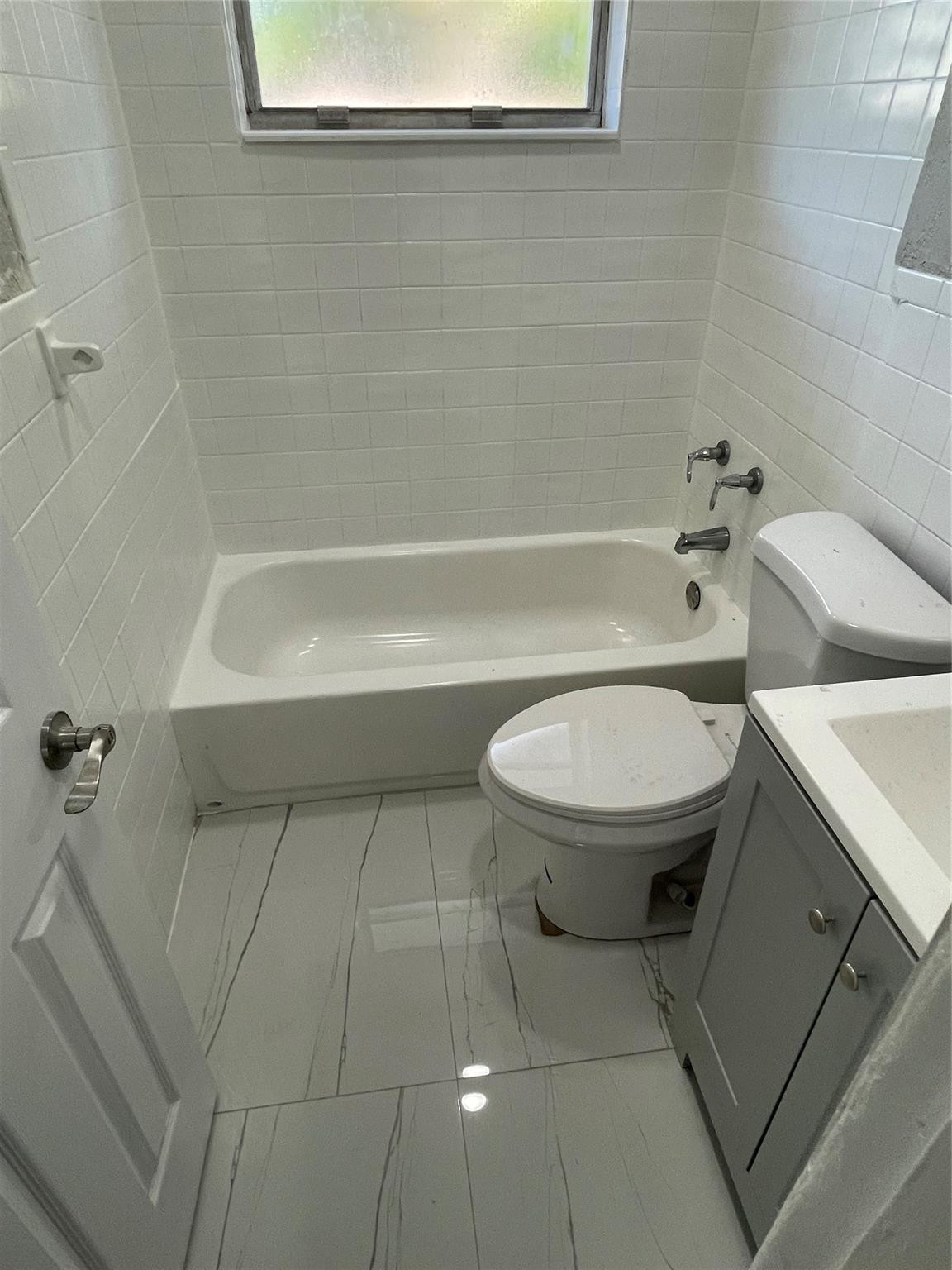 721 Southwest 8th Street Pompano Beach, FL 33060 - Photo 11 of 21 a bathroom with a toilet and a bathtub