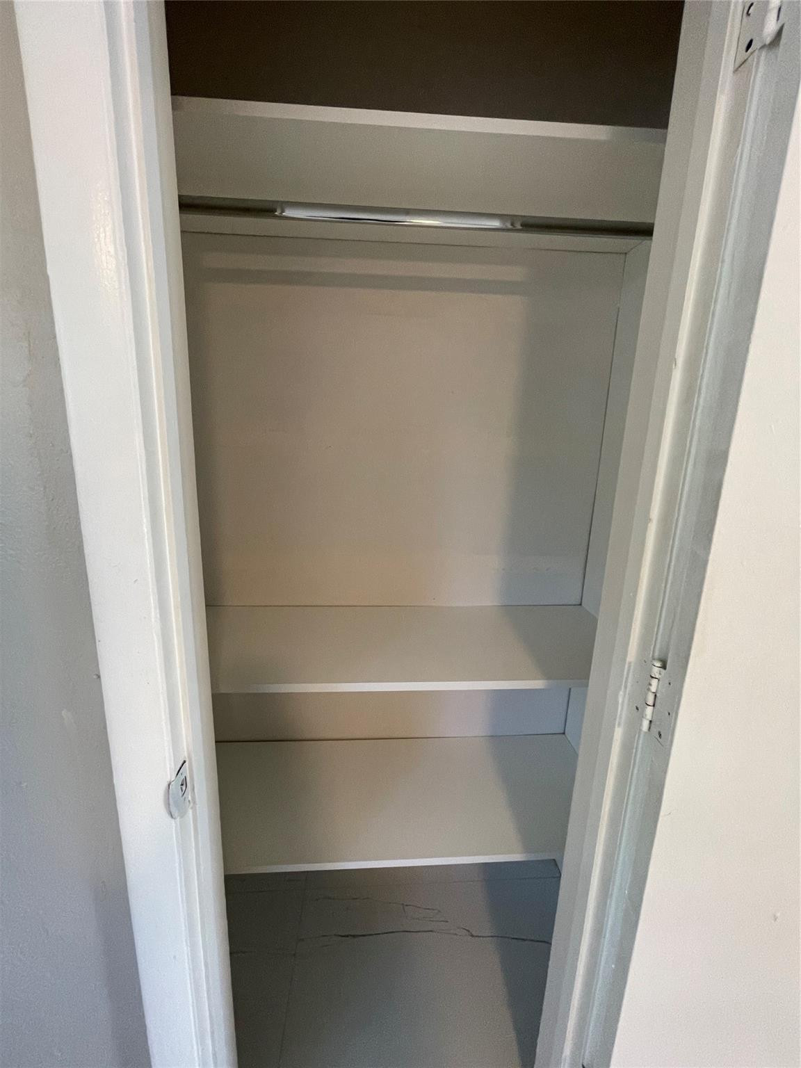 721 Southwest 8th Street Pompano Beach, FL 33060 - Photo 18 of 21 a view of walk in closet with empty racks