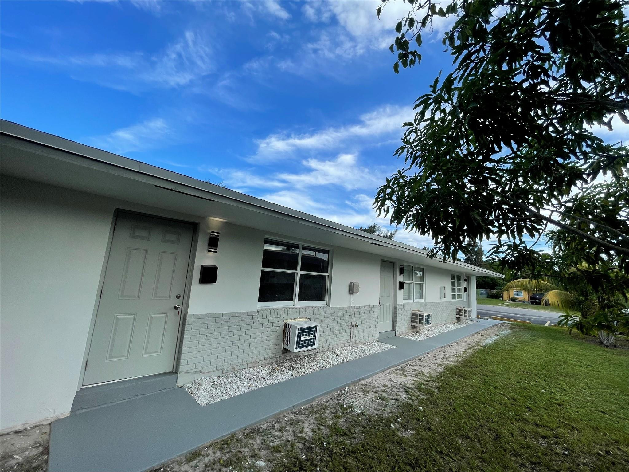 721 Southwest 8th Street Pompano Beach, FL 33060 - Photo 2 of 21 a front view of a house with garden