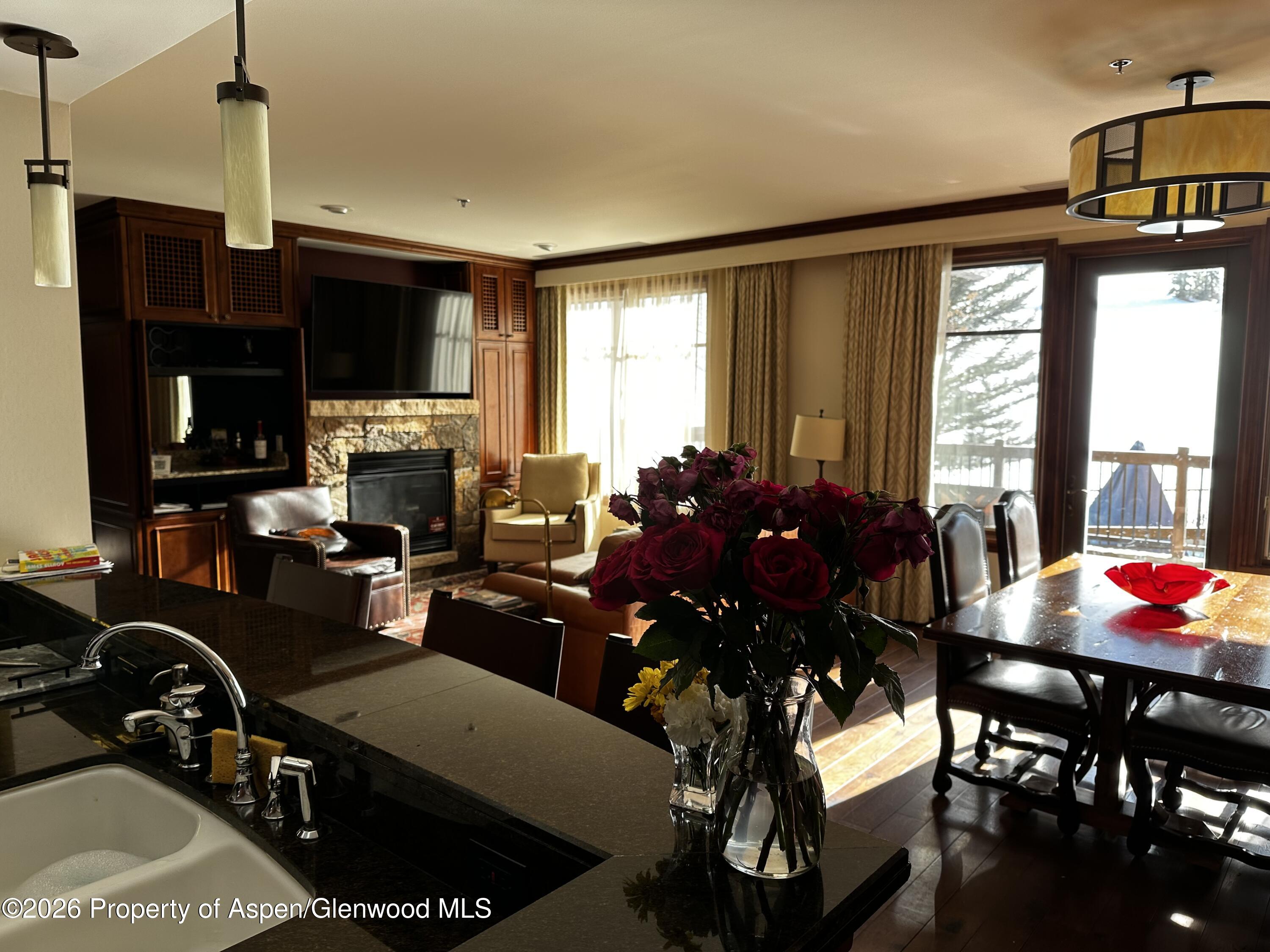 197 Prospector Road, Unit 22052 Aspen, CO 81611 - Photo 4 of 22 a living room with furniture a flat screen tv and a window