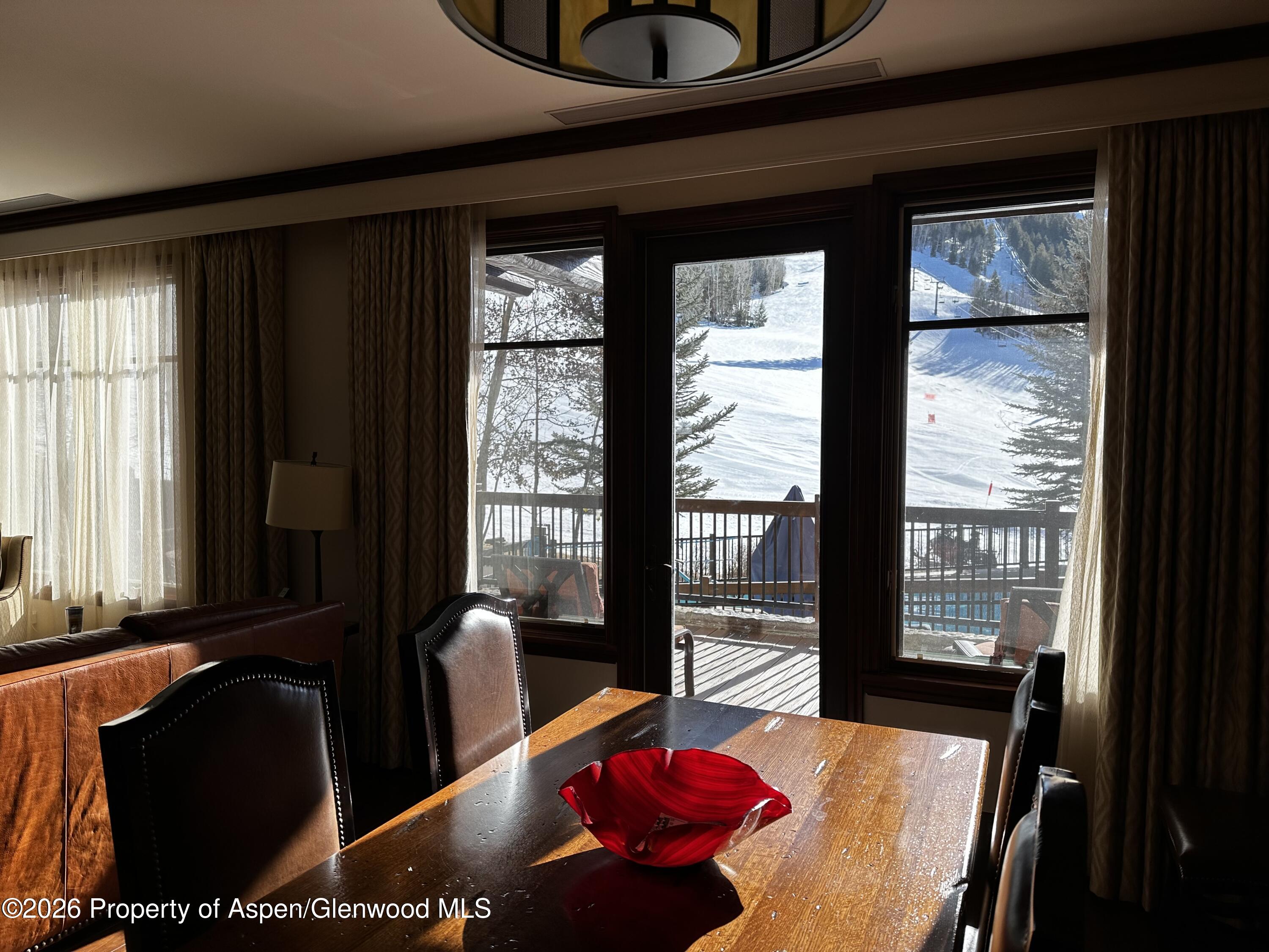 197 Prospector Road, Unit 22052 Aspen, CO 81611 - Photo 5 of 22 a living room with furniture and large windows