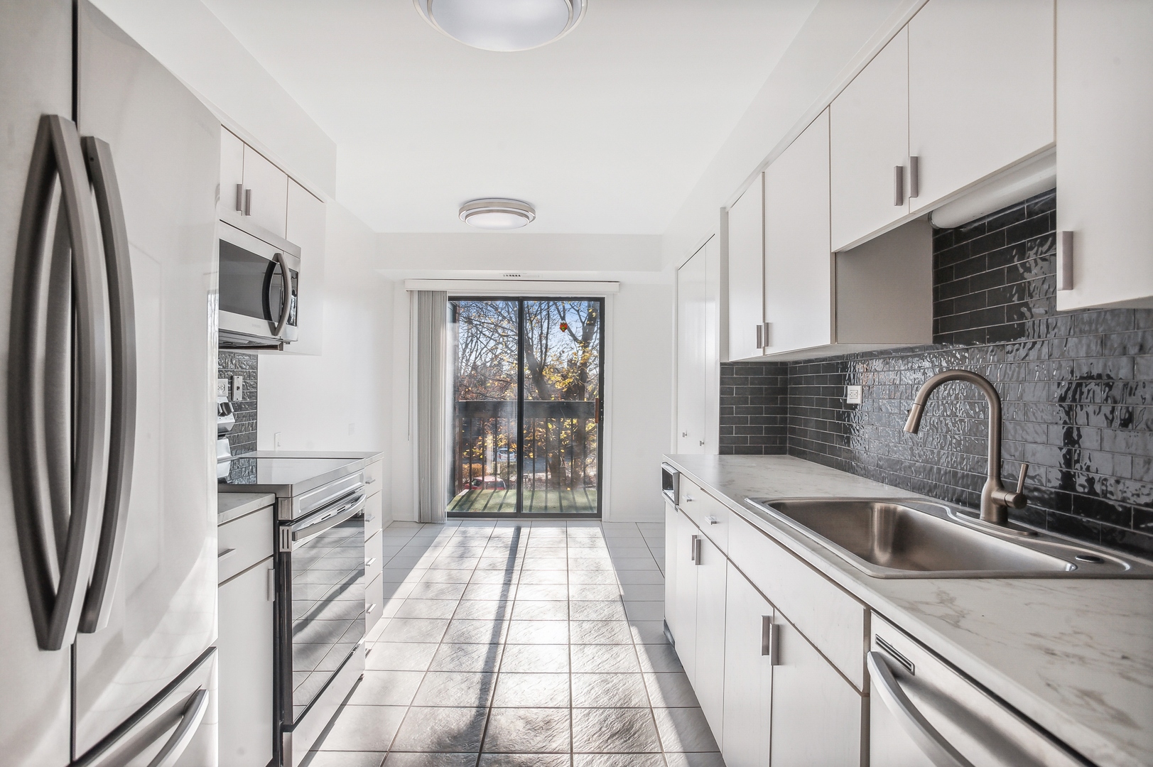 3900 Mission Hills Road, Unit 204 Northbrook, IL 60062 - Photo 8 of 15 a kitchen with stainless steel appliances granite countertop a refrigerator a sink a stove and white cabinets
