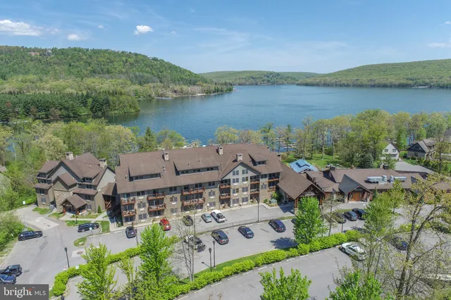an aerial view of a house with lake view