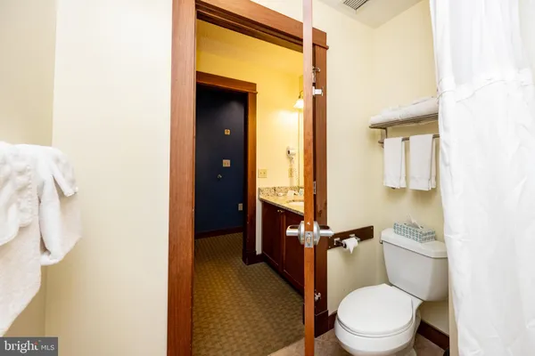a white toilet sitting next to a bathroom sink