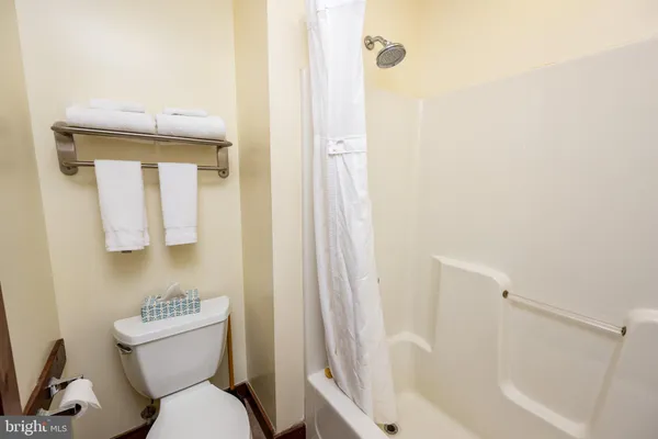 a white toilet sitting next to a bathroom sink