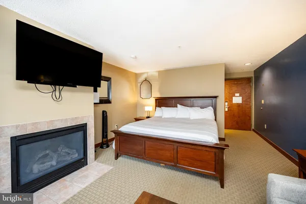 a bedroom with a bed and a flat screen tv