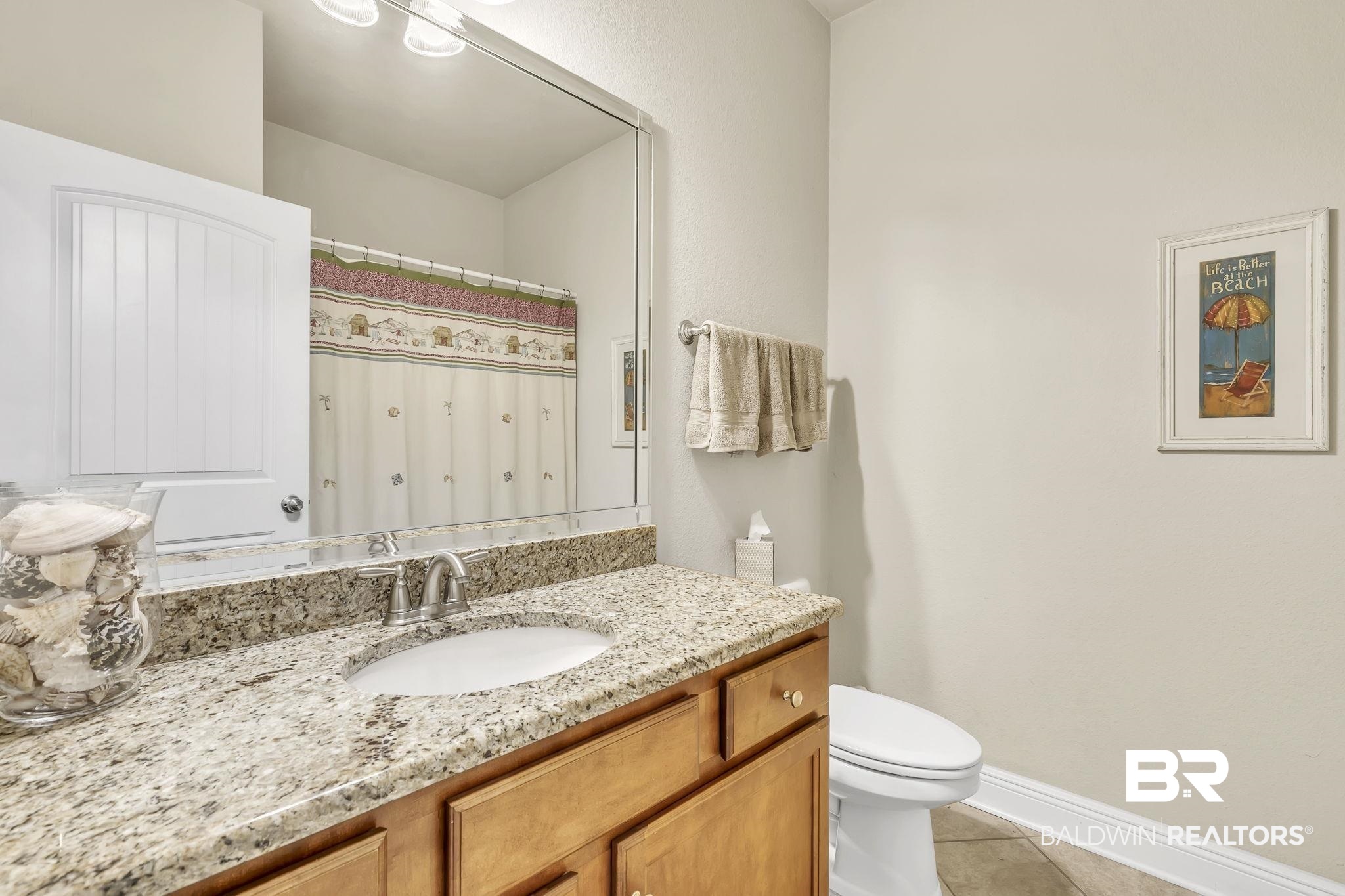 21439 Brick Stack Lane Fairhope, AL 36532 - Photo 23 of 32 Full bath featuring baseboards, toilet, curtained shower, vanity, and tile patterned flooring