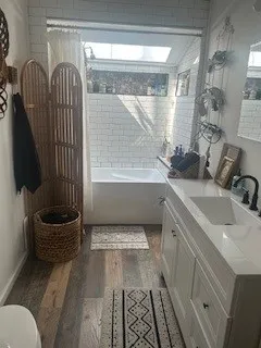 a bathroom with a sink a toilet and bathtub