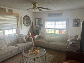 a living room with furniture a clock and a window