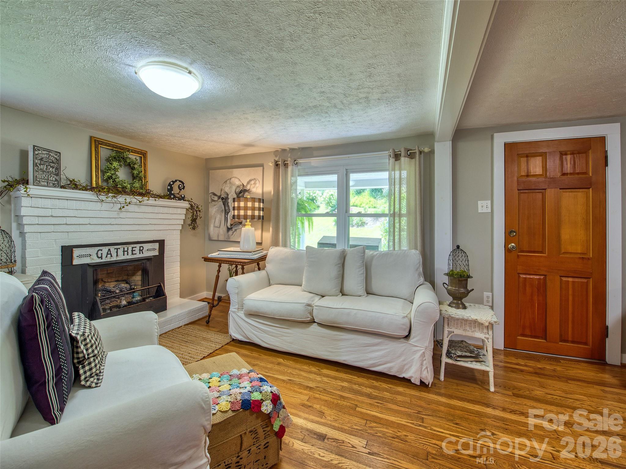9 Whitted Road Canton, NC 28716 - Photo 15 of 24 a living room with furniture and a fireplace