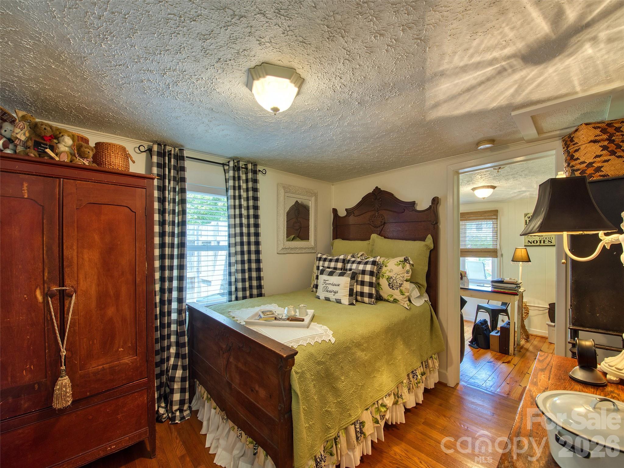 9 Whitted Road Canton, NC 28716 - Photo 22 of 24 a spacious bedroom with a bed and wooden floor