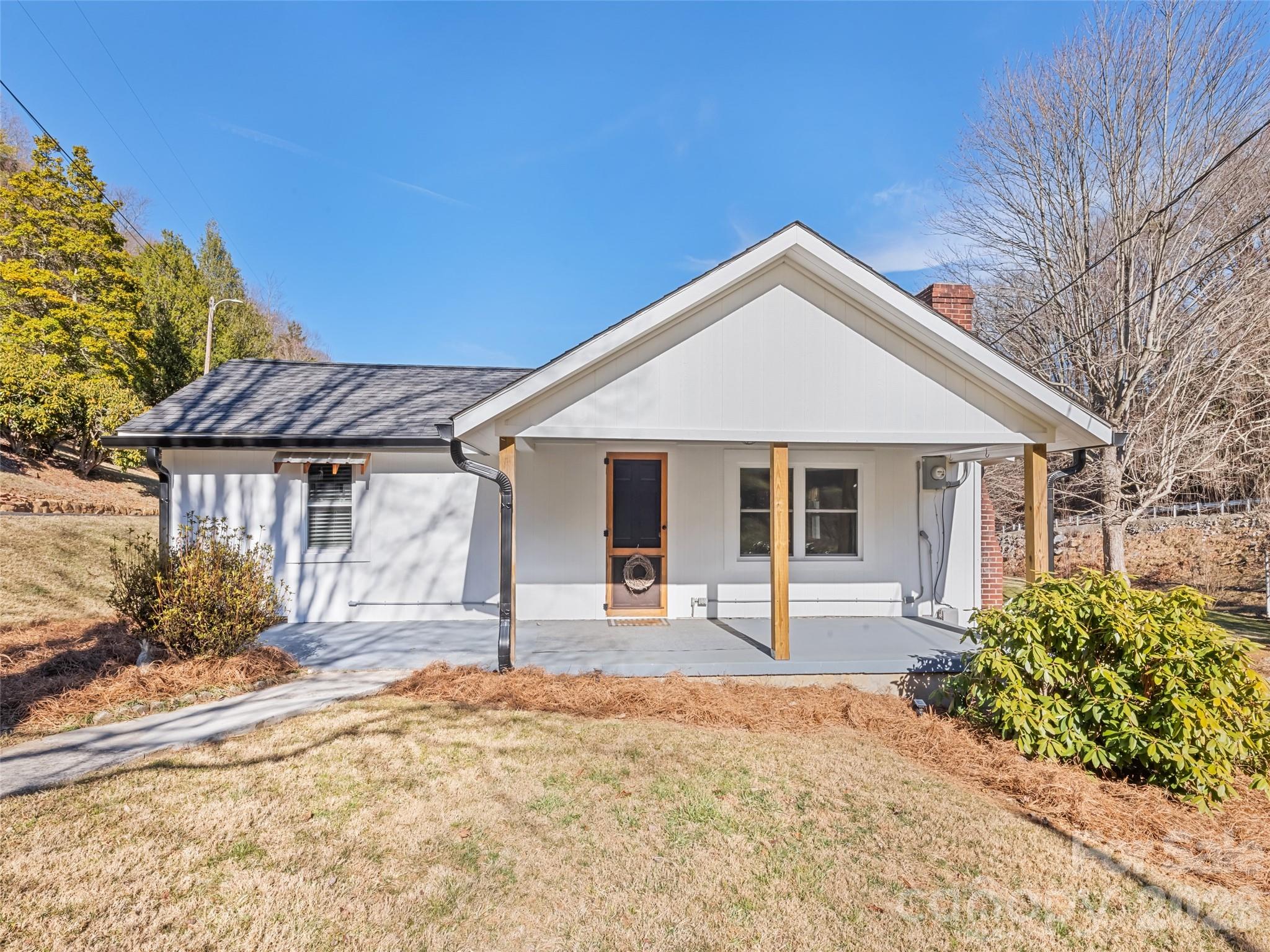9 Whitted Road Canton, NC 28716 - Photo 7 of 24 a front view of a house with a yard and garage