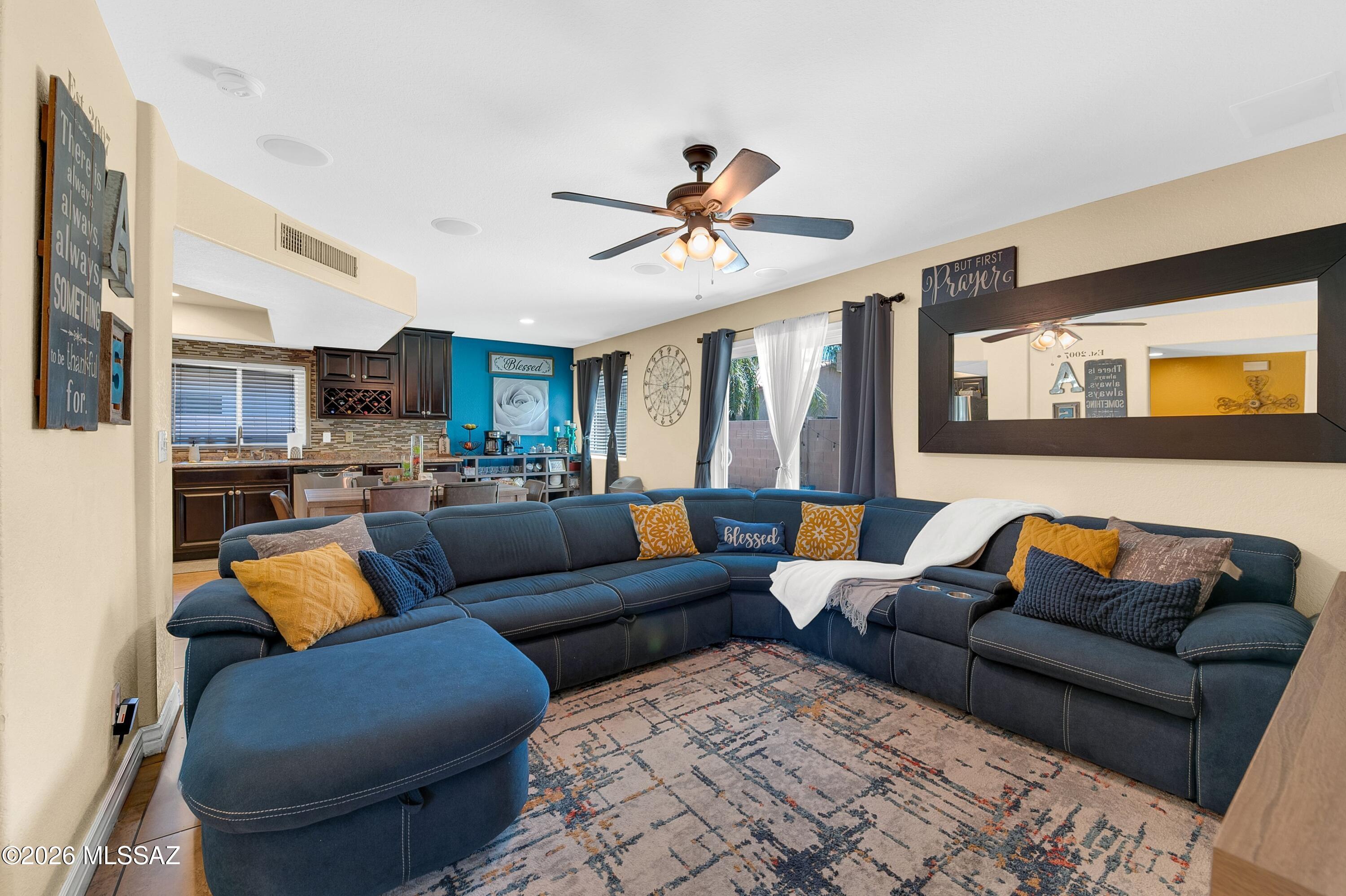 7159 West Maple Ridge Drive Tucson, AZ 85743 - Photo 10 of 42 a living room with furniture ceiling fan and a rug